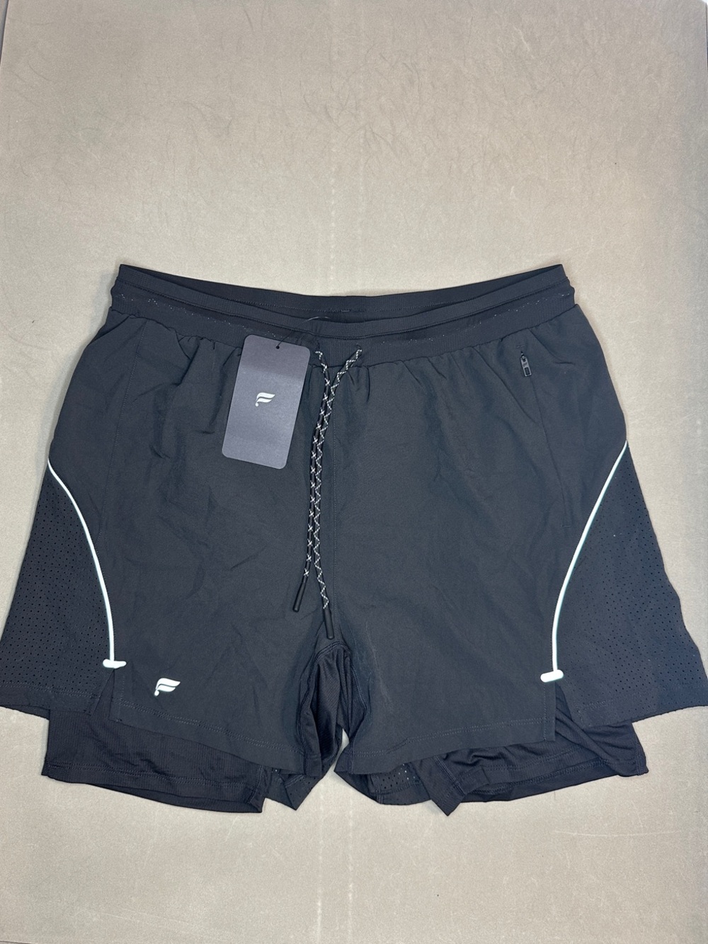 Fabletics the 5” Kadence short Lined Men’s Black with reflective logo. - L